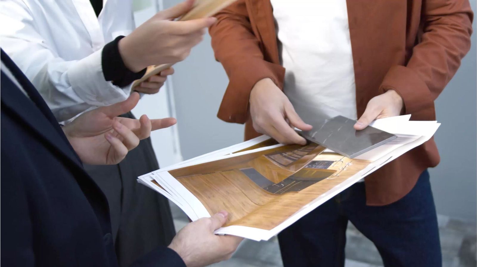 Amaya designers reviewing materials with a client