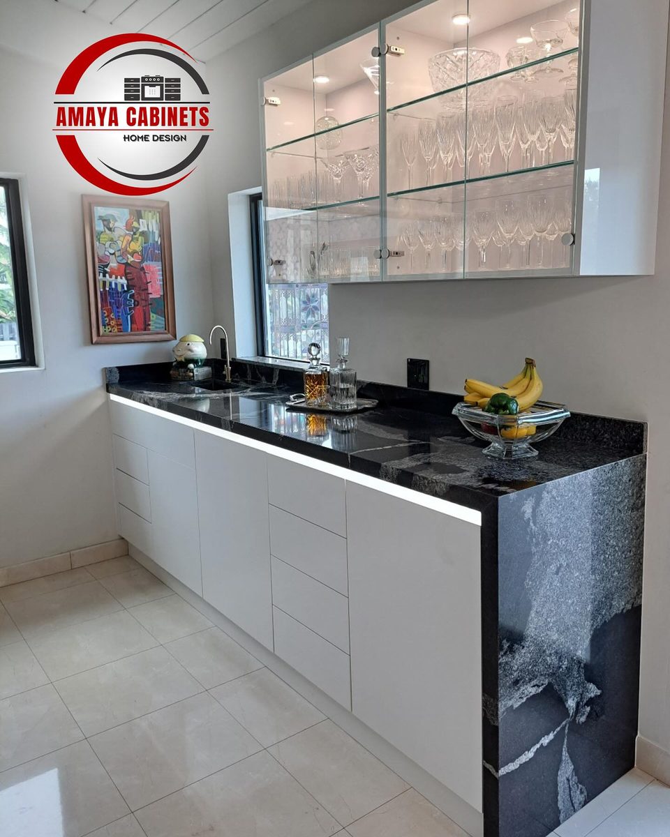 Kitchen with glass-front upper cabinets and black granite countertops