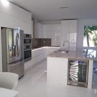 White gloss kitchen with built-in ovens, wine cooler and stone island