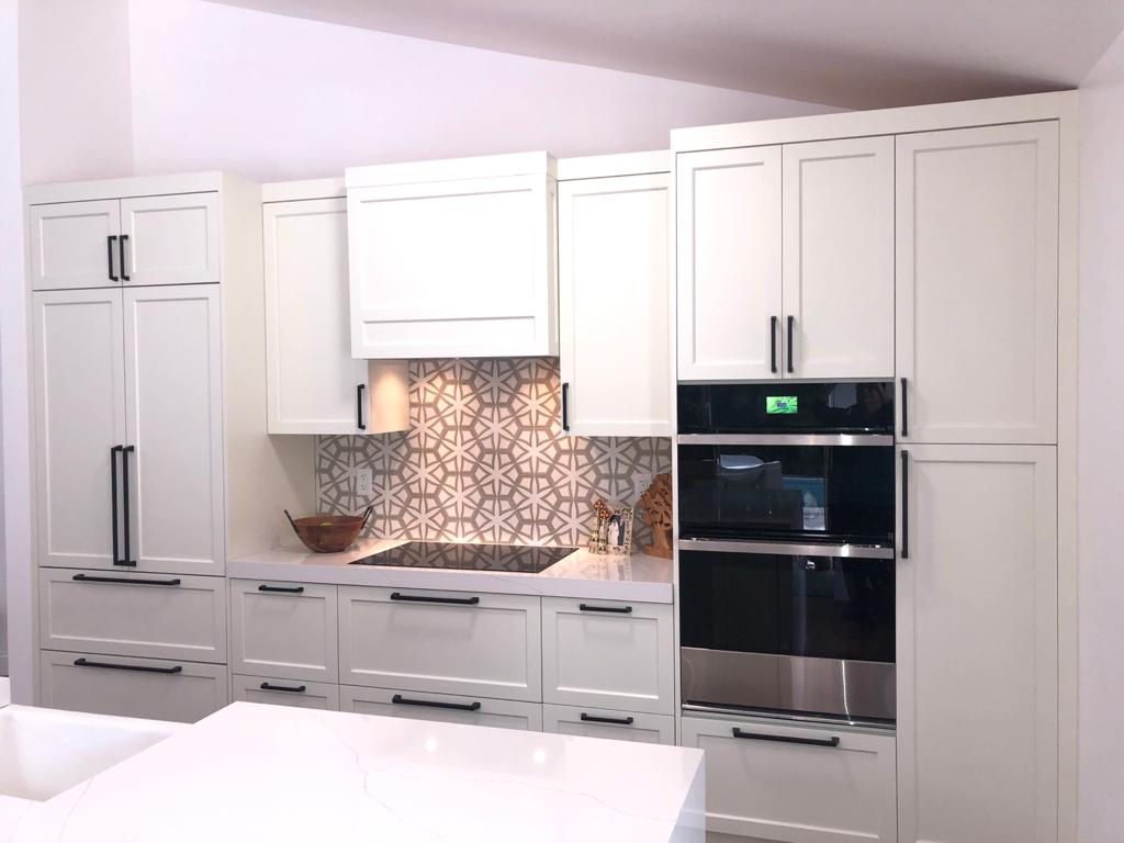 Classic kitchen with patterned backsplash and double ovens