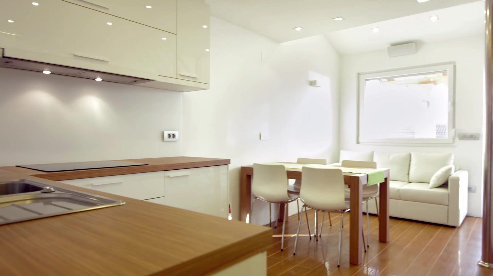 Open-plan kitchen and living area with wood peninsula