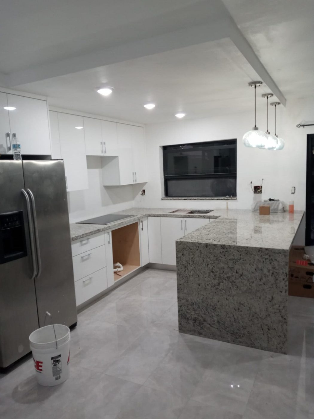 Kitchen with granite waterfall island and stainless appliances