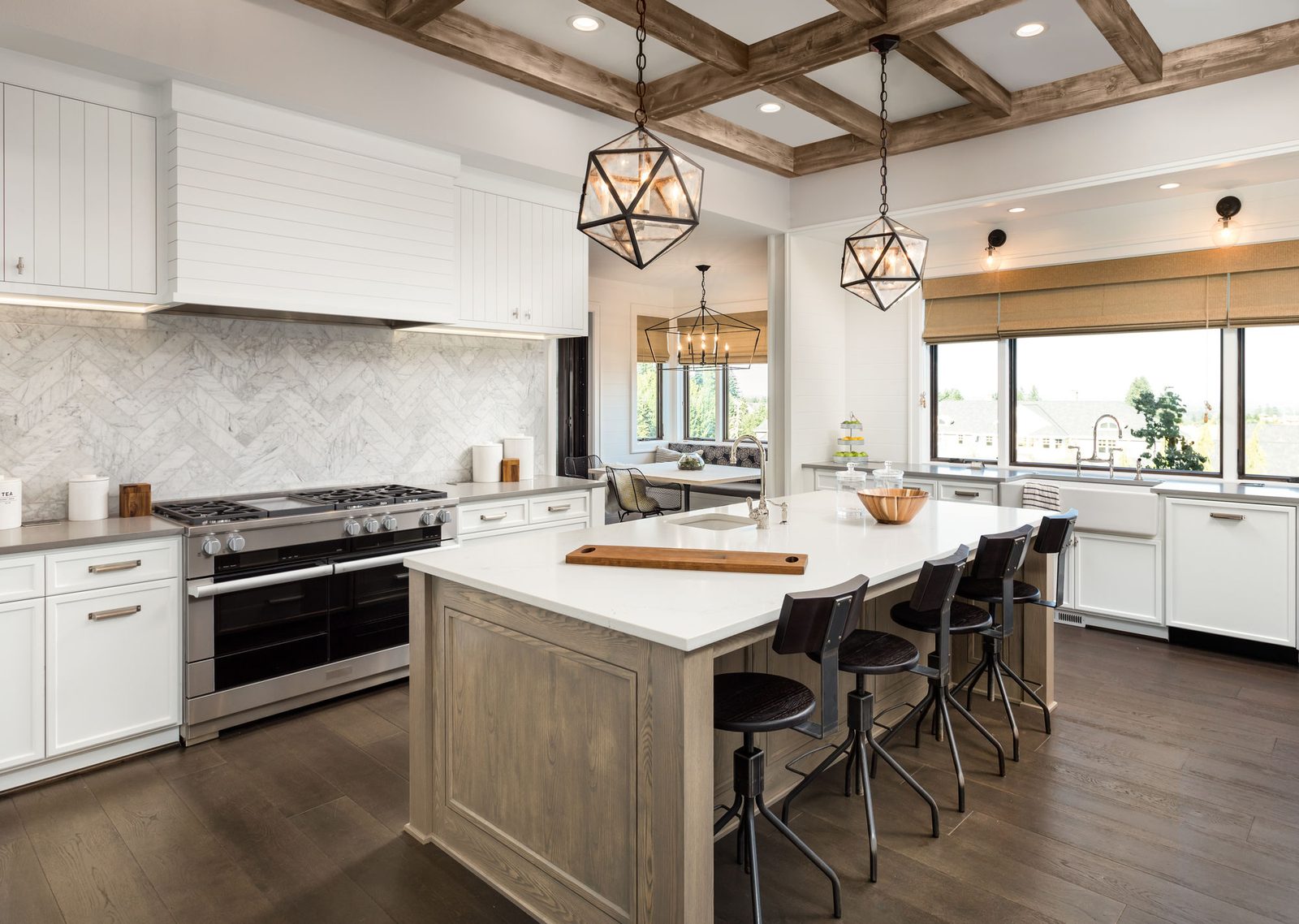 Custom kitchen with marble backsplash and wood island by Amaya